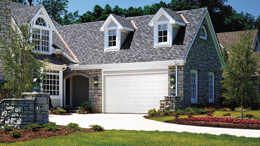 clopay value series heavy duty affordable garage door on stone house