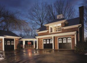 clopay reserve wood custom handcrafted wooden garage doors at night